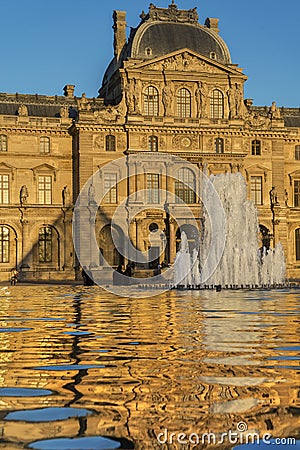 The Louvre Museumâ€™s cour NapolÃ©on under the setting sun Editorial Stock Photo